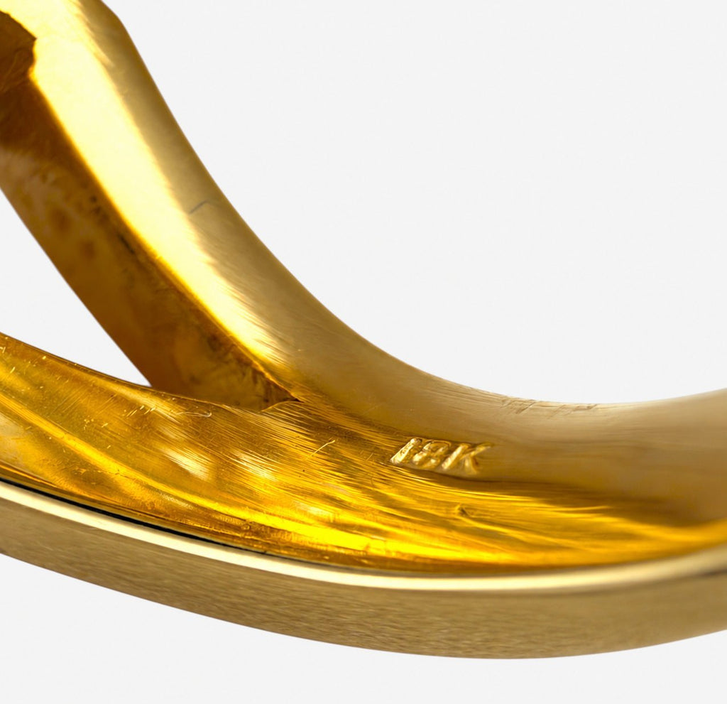 Gold ring interior close-up with stamped hallmark and smooth polished band