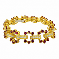 Yellow gold bracelet with diamond bar center links and ruby cluster bezel settings