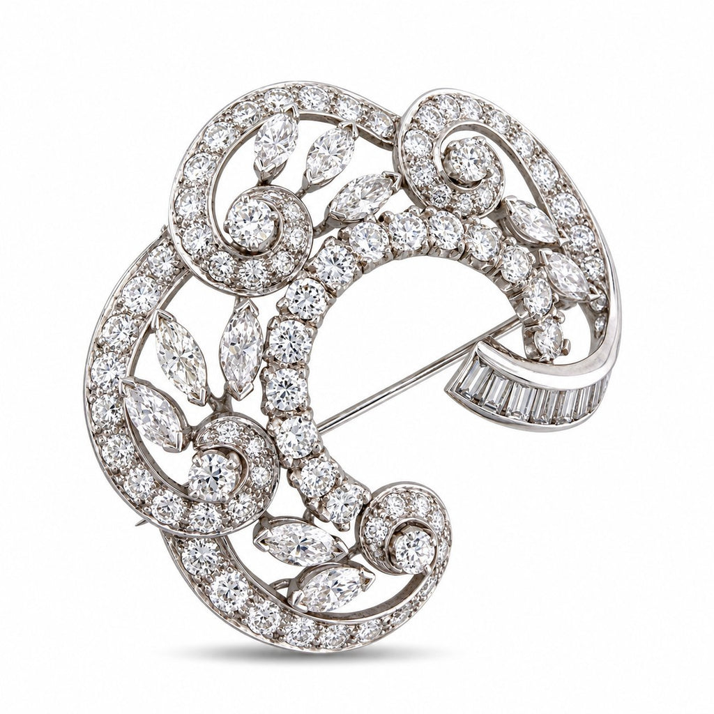 18K white gold diamond swirl brooch with round and pear stones, angled view.