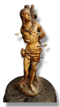 Gilded carved wooden robed woman figure holding small staffs, standing on a round base