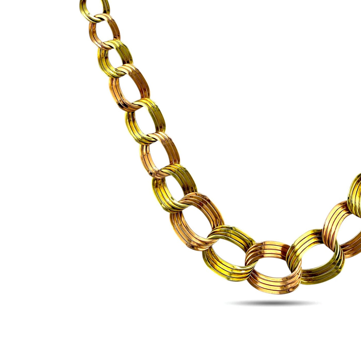 Gold tone chain necklace with oval and circular graduated links detail, close-up