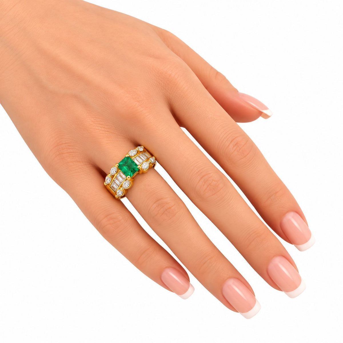 Yellow gold emerald and diamond ring on hand, green center stone with diamond band