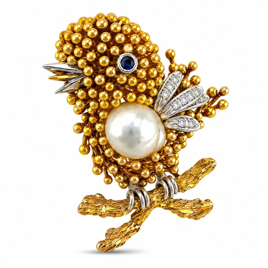 Gold-toned bird brooch with round pearl, blue sapphire eye, diamond feather accents