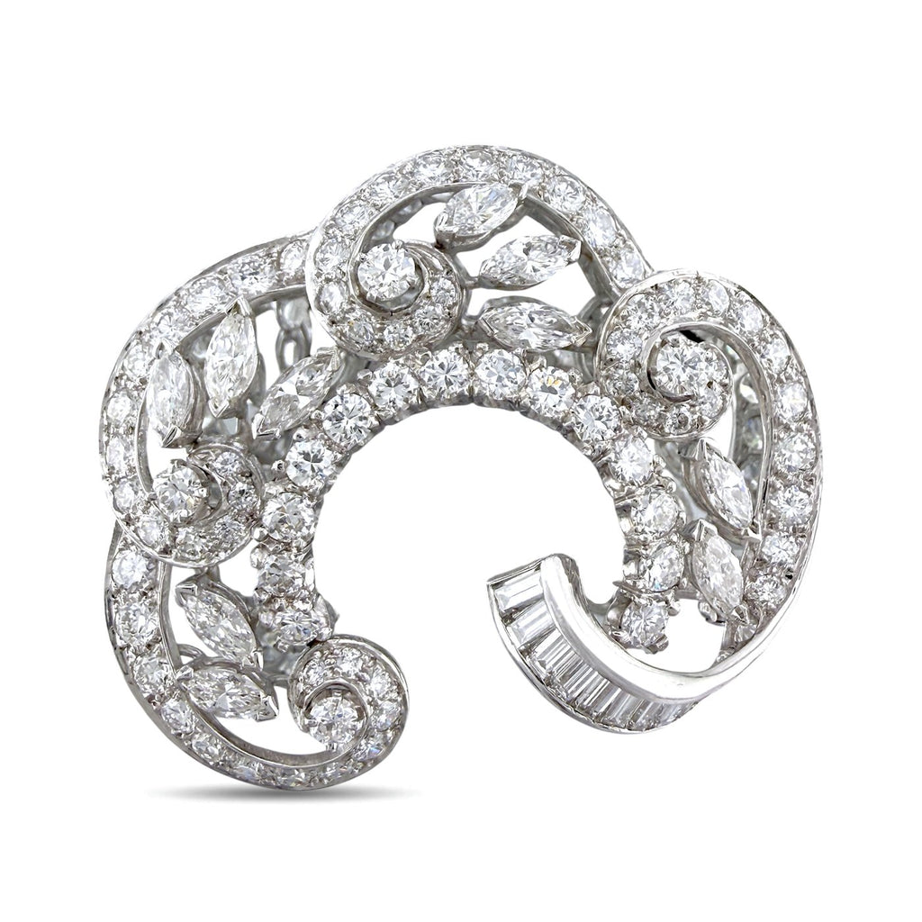 18K white gold diamond swirl brooch with baguette and round stones, open frame.
