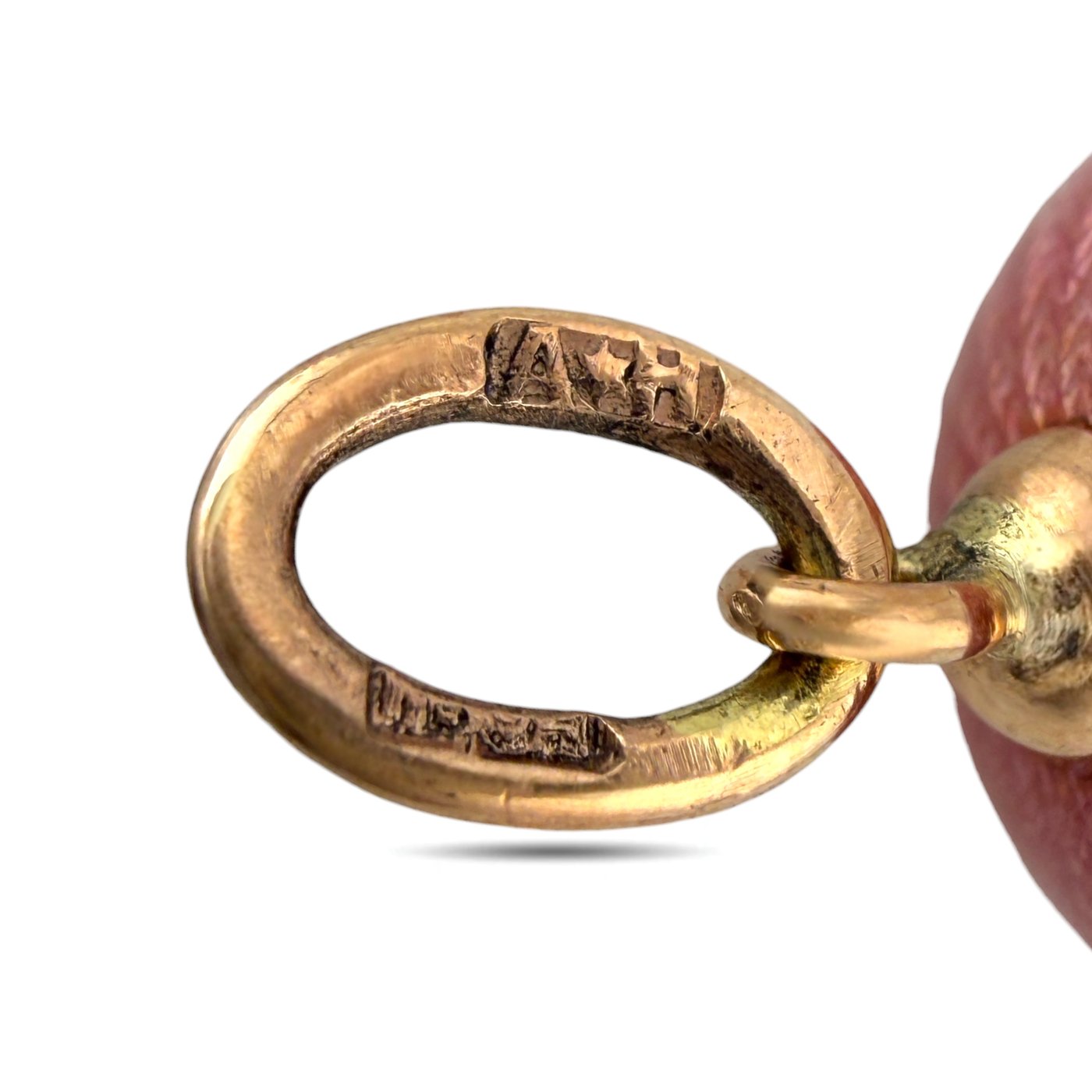 Close-up of gold tone oval connector loop on the egg pendant chain holder.