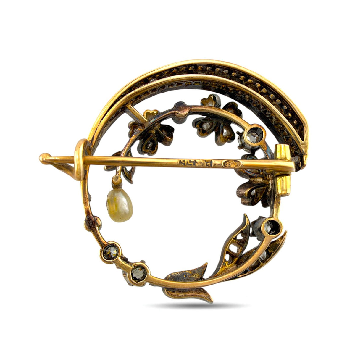 Back of the brooch showing its gold pin, clasp, and openwork floral setting