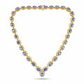 Yellow gold necklace with oval blue gemstones and small clear stones set in rows