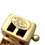 Gold clasp close-up with engraved Triomphe and black onyx inset squares