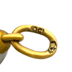 Close-up of gold-tone pendant bail with hallmarks