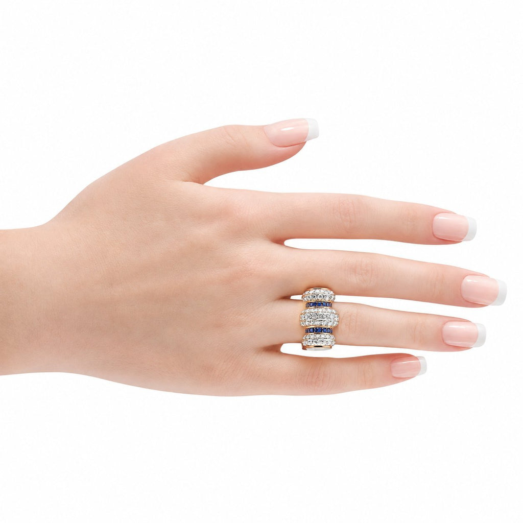 Antique 14K rose gold diamond and sapphire bombe ring on a hand