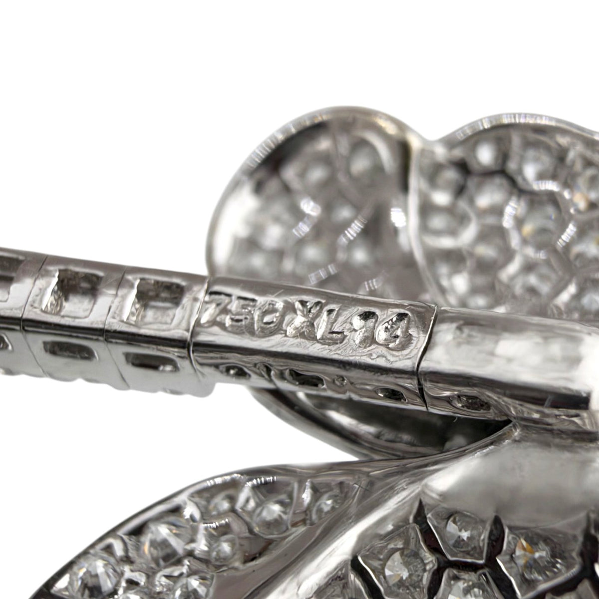 Close-up of the bracelet's 18K white gold hallmark and diamond setting