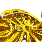 Close-up of yellow gold earring back with prongs and hinged clasp