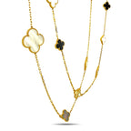 Gold long necklace close-up with clover charms and chain links, mother-of-pearl and onyx mix