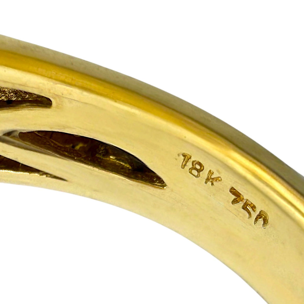 Inside of yellow gold ring band showing engraved '18K' hallmark