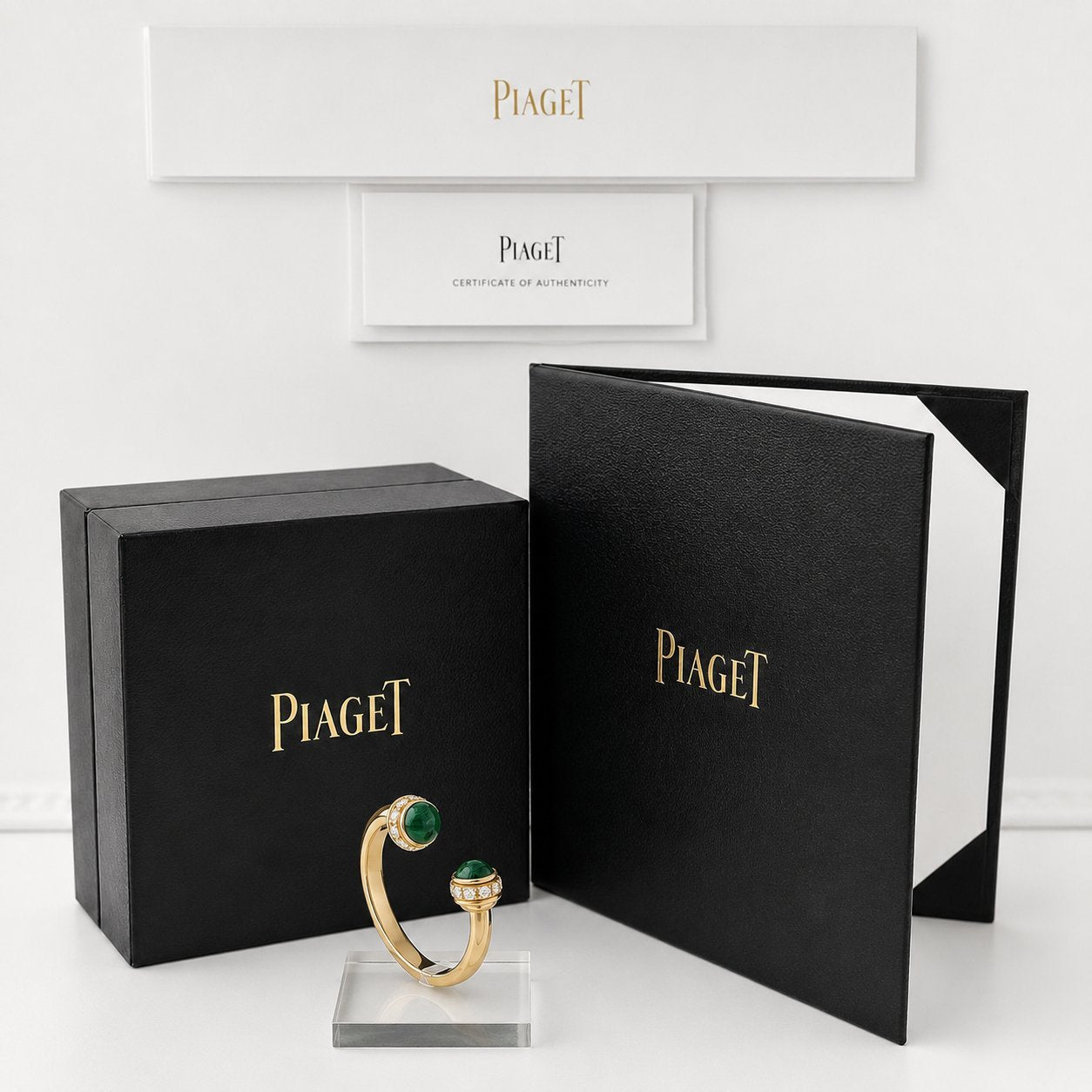 Piaget jewelry boxes and certificate with gold chrysoprase diamond ring on stand