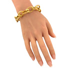 18K yellow gold textured oval link bracelet on hand, bright interlocking oval links