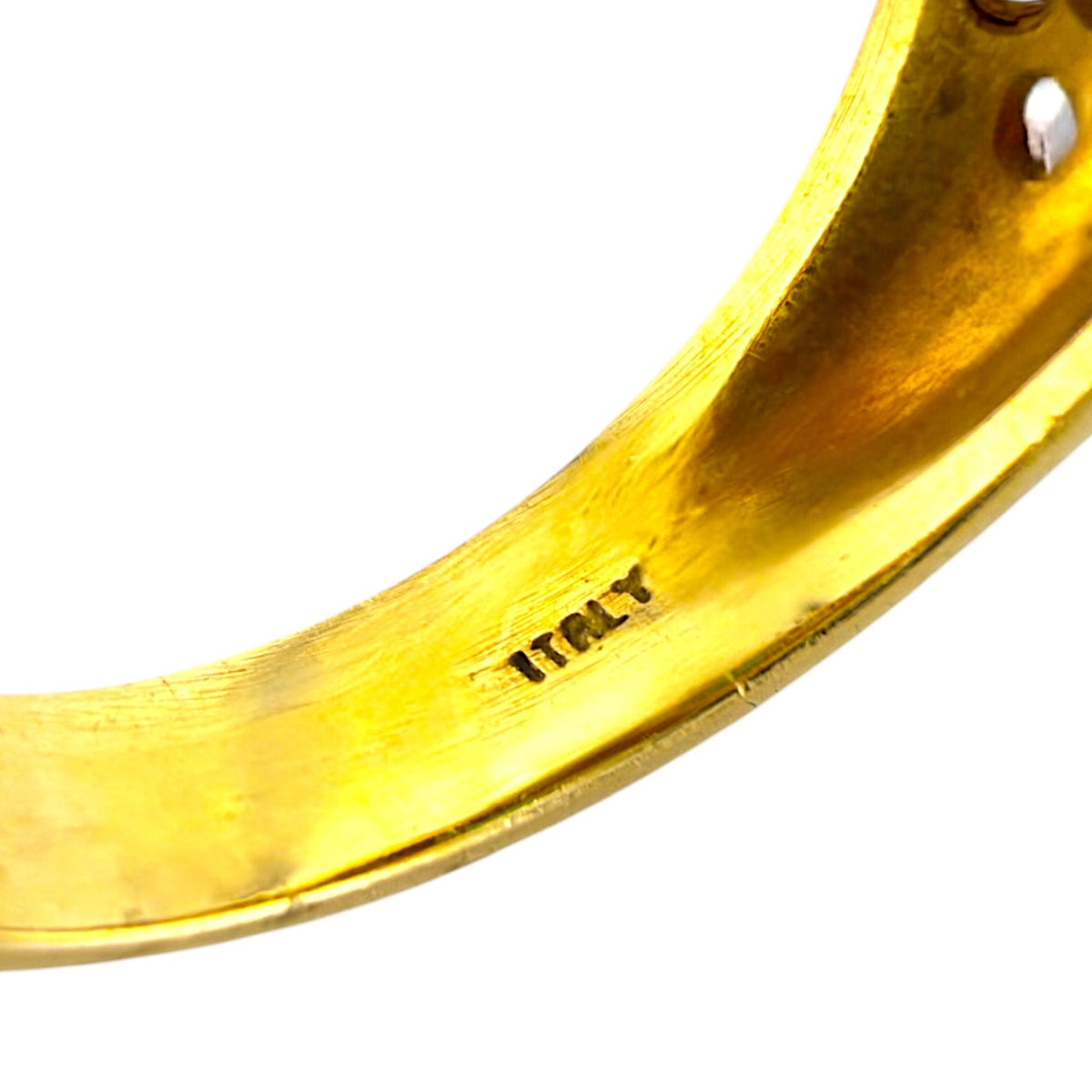 Close-up of inside yellow gold band with '18K' hallmark and polished finish