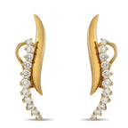 Yellow gold clip-on earrings featuring leaf fronts and cascading round diamonds for sparkle.