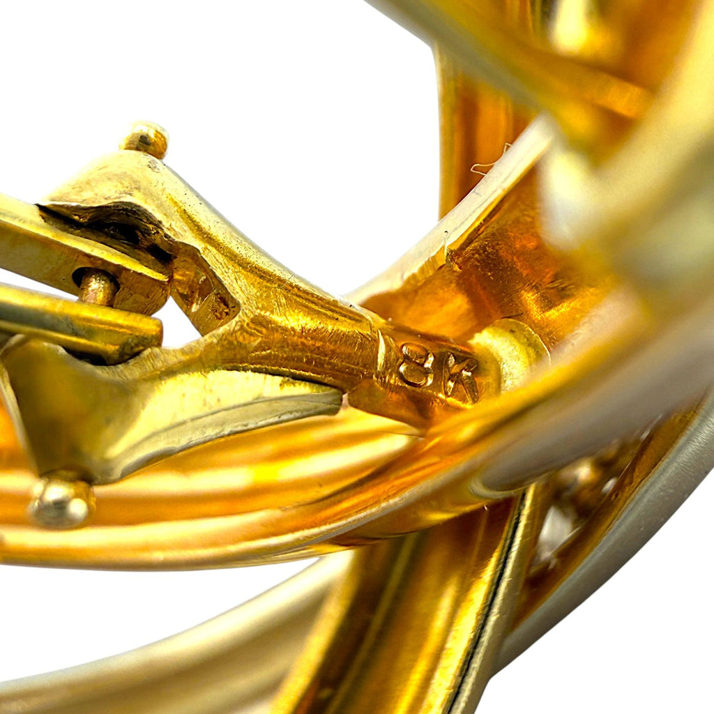 Close-up of gold clip hinge with engraved details on the clasp mechanism