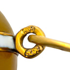 Close-up of the pig pendant's gold-tone attachment ring and engraved hallmarks.