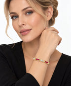 Yellow gold ruby and diamond bracelet on wrist, shown with model wearing it.