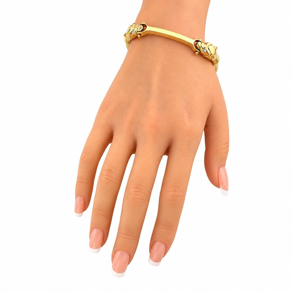 14K yellow gold cheetah head link bracelet on wrist, front view