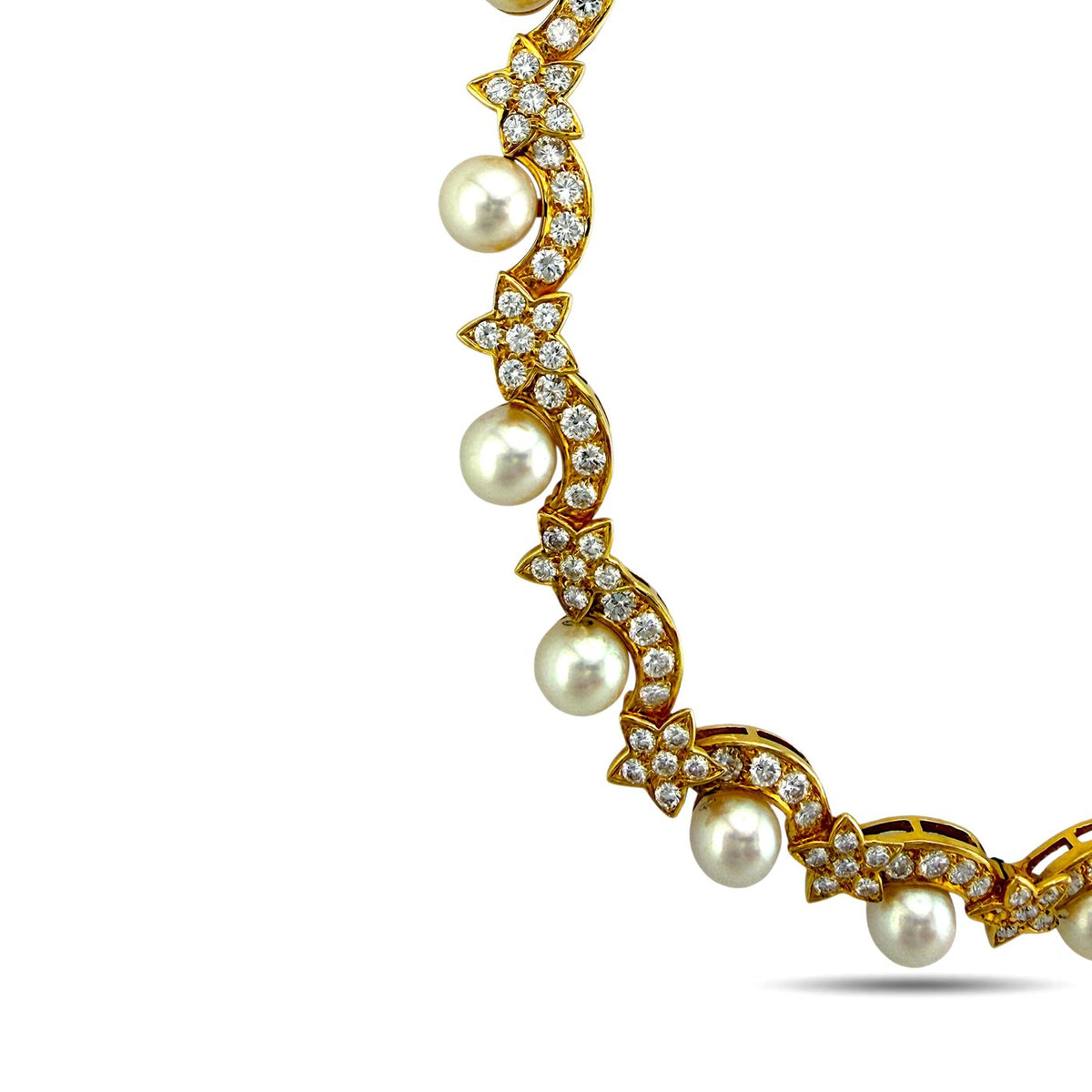 Close-up of yellow gold choker links with white pearl beads and diamond accents