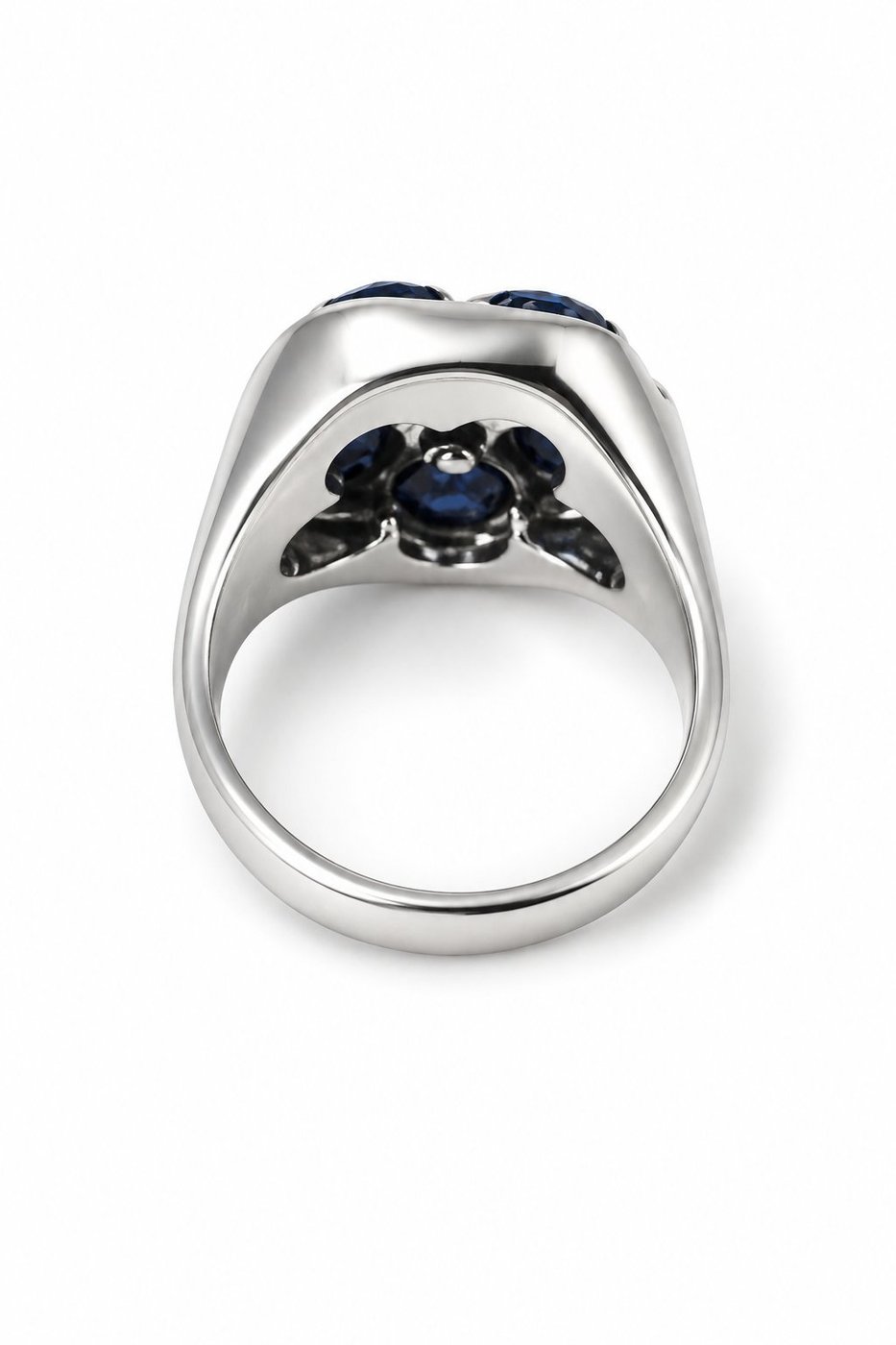 White gold ring underside with blue sapphire center stone and claw prongs