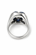 White gold ring underside with blue sapphire center stone and claw prongs