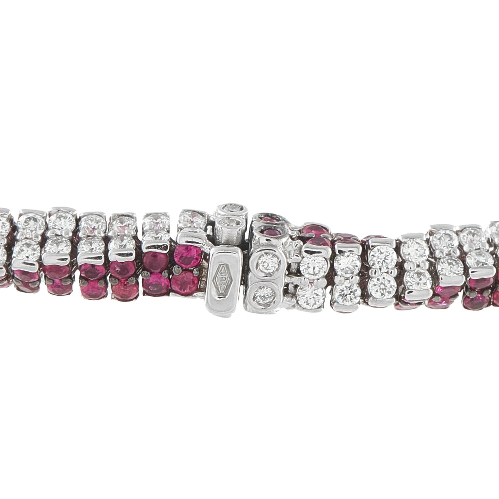 Close-up diamond and ruby snake bracelet segment with hinged clasp and alternating stone links