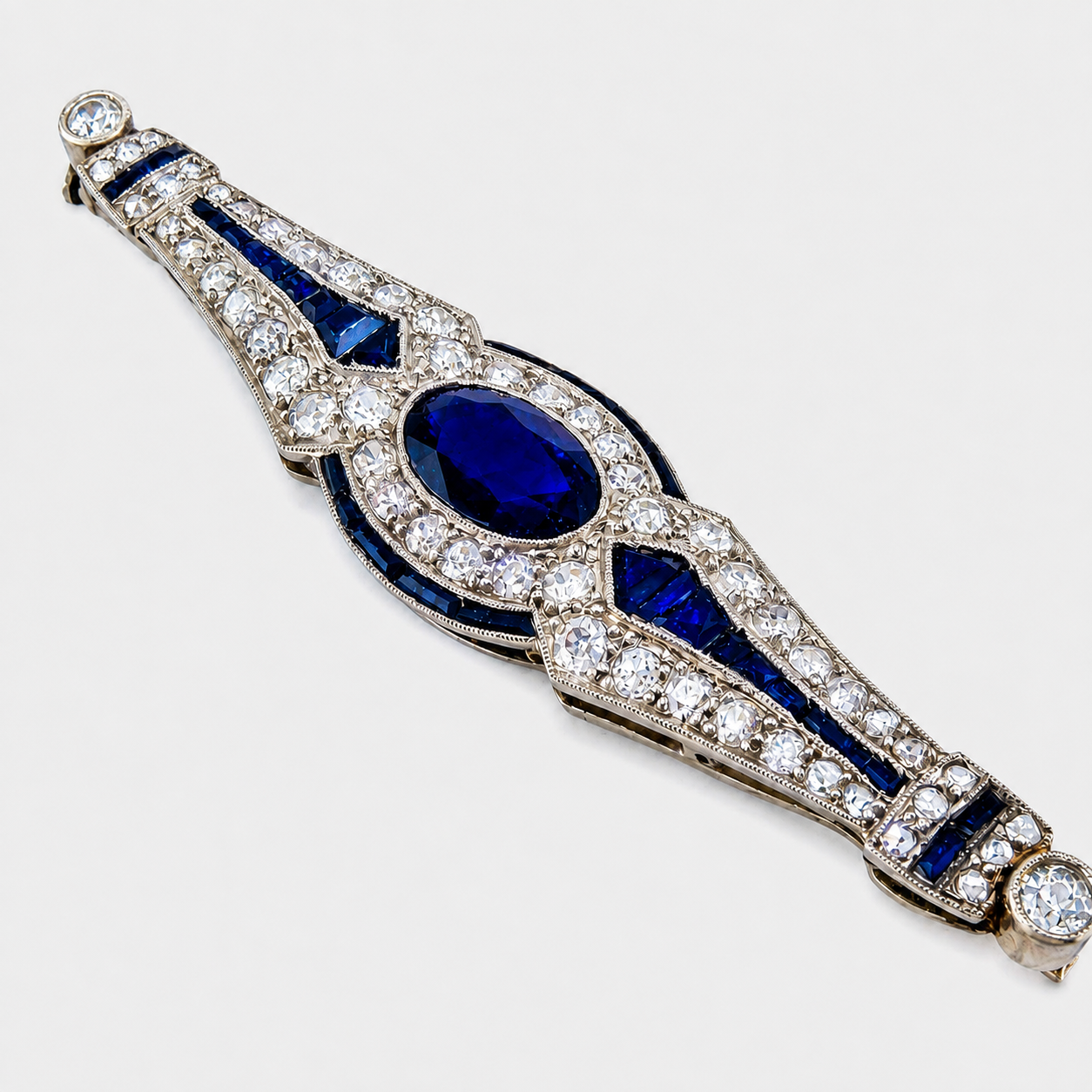 Art Deco sapphire and diamond platinum brooch with blue oval center stones