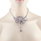 Diamond and sapphire necklace on model neck, blue floral pendant with dangling drops