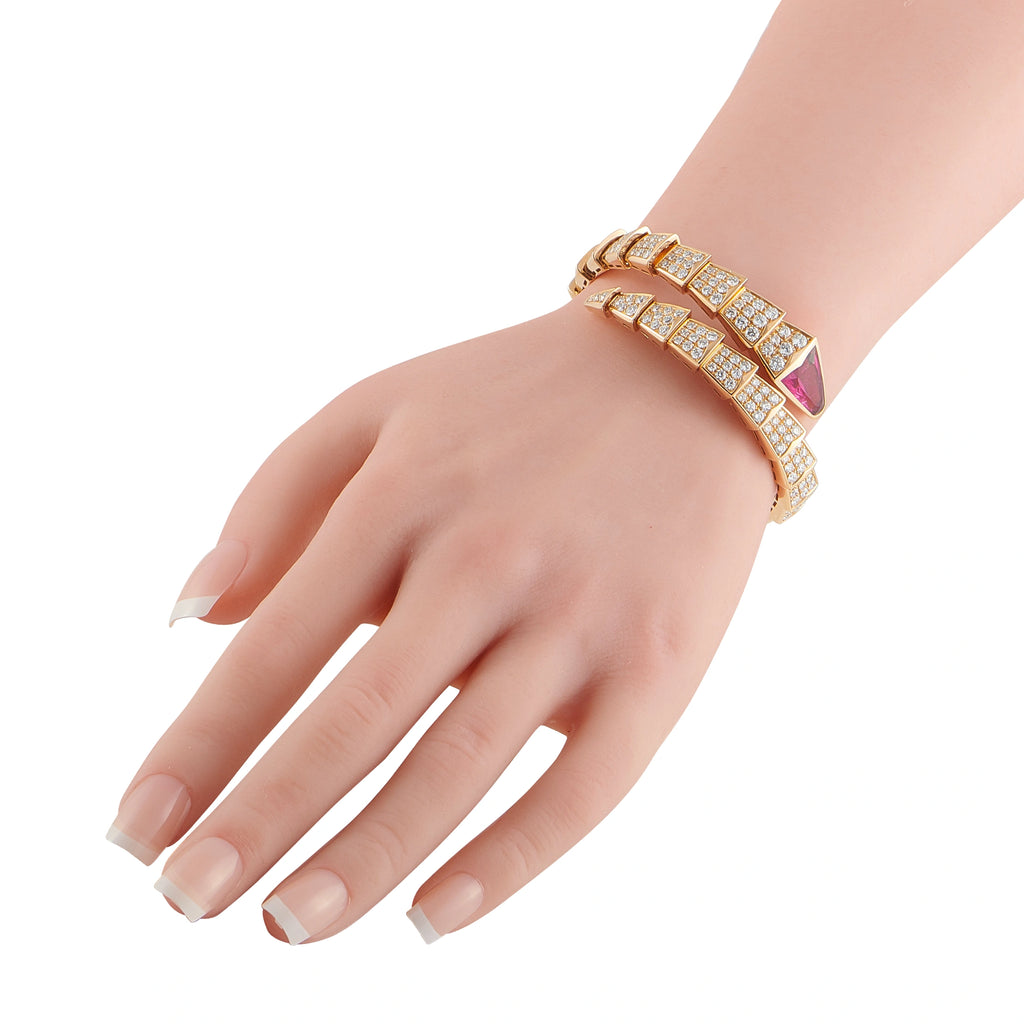 Rose gold diamond bracelet with pink center stone, worn on wrist