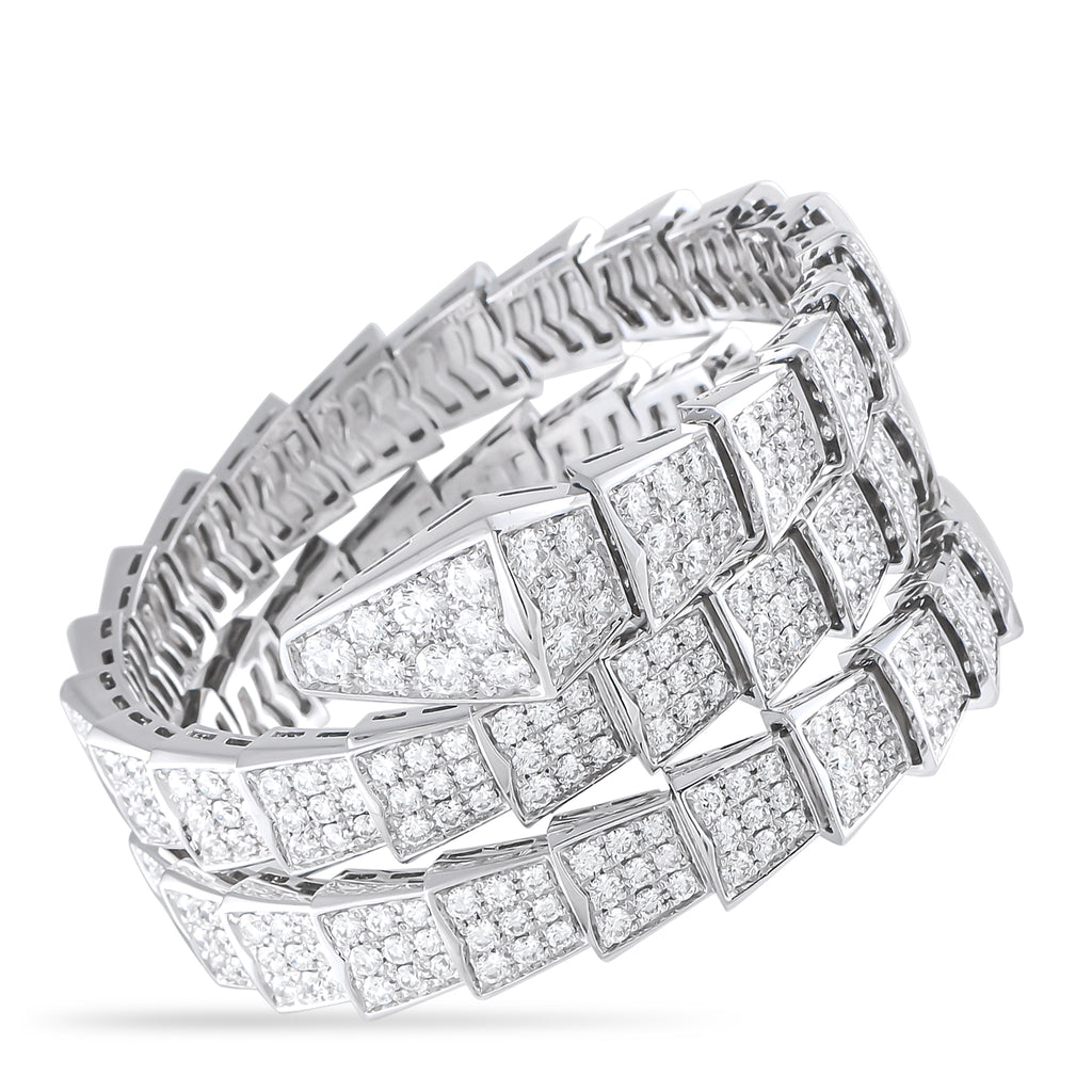 Diamond-set white gold bracelet with repeating scale-like links and open lattice design.