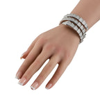 Diamond-set white gold bracelet on wrist with sleek multi-row linked bands.