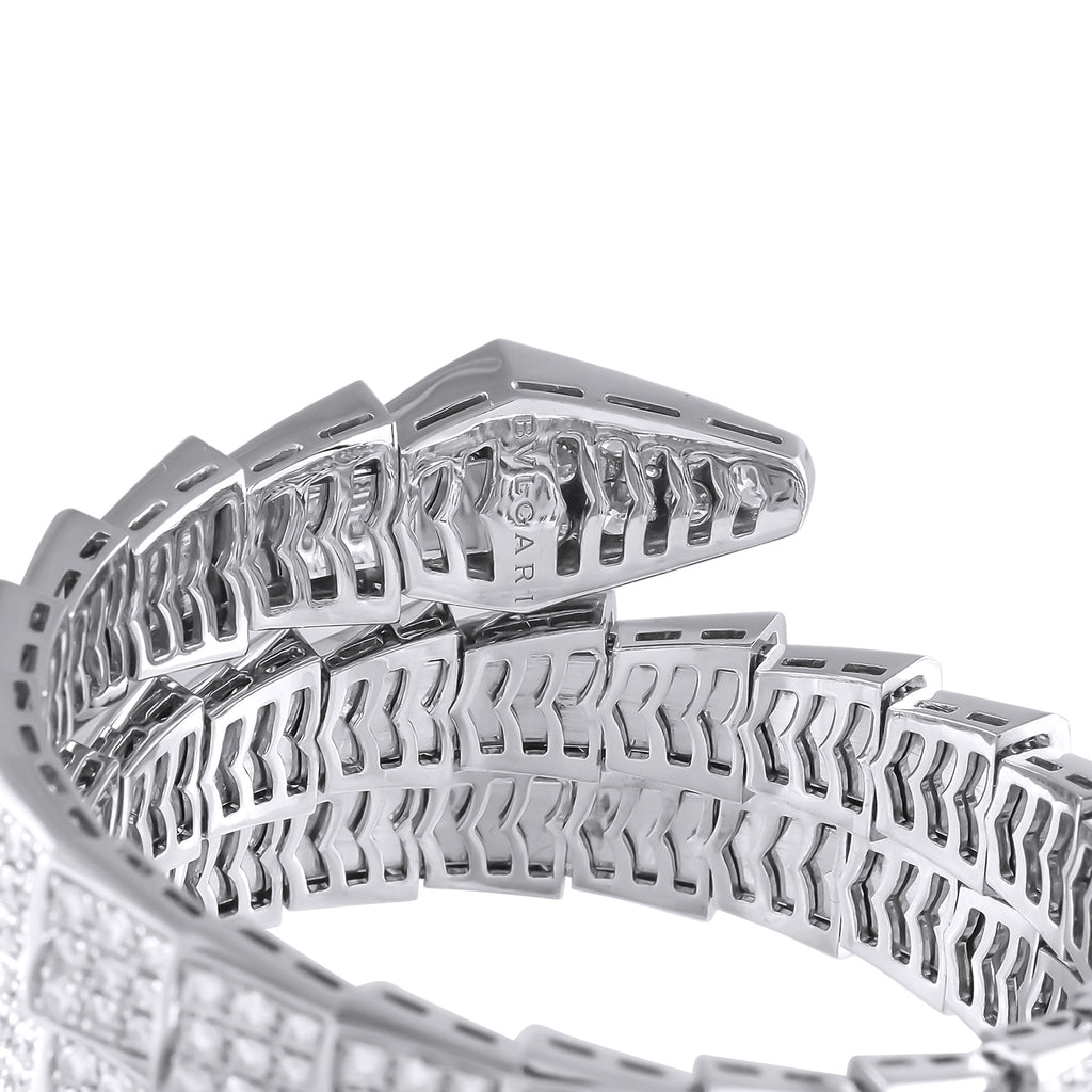 Close-up of white gold bracelet links with diamond-set panels and openwork backing.
