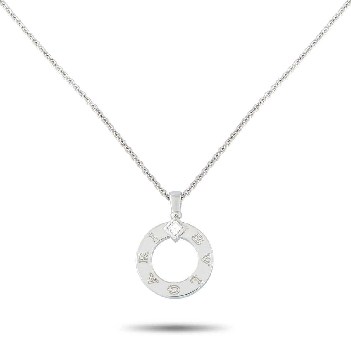 White gold circular diamond pendant with open ring design and logo engravings