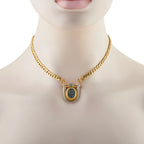 Gold necklace on mannequin with shield pendant, blue oval intaglio and purple ruby-like stones