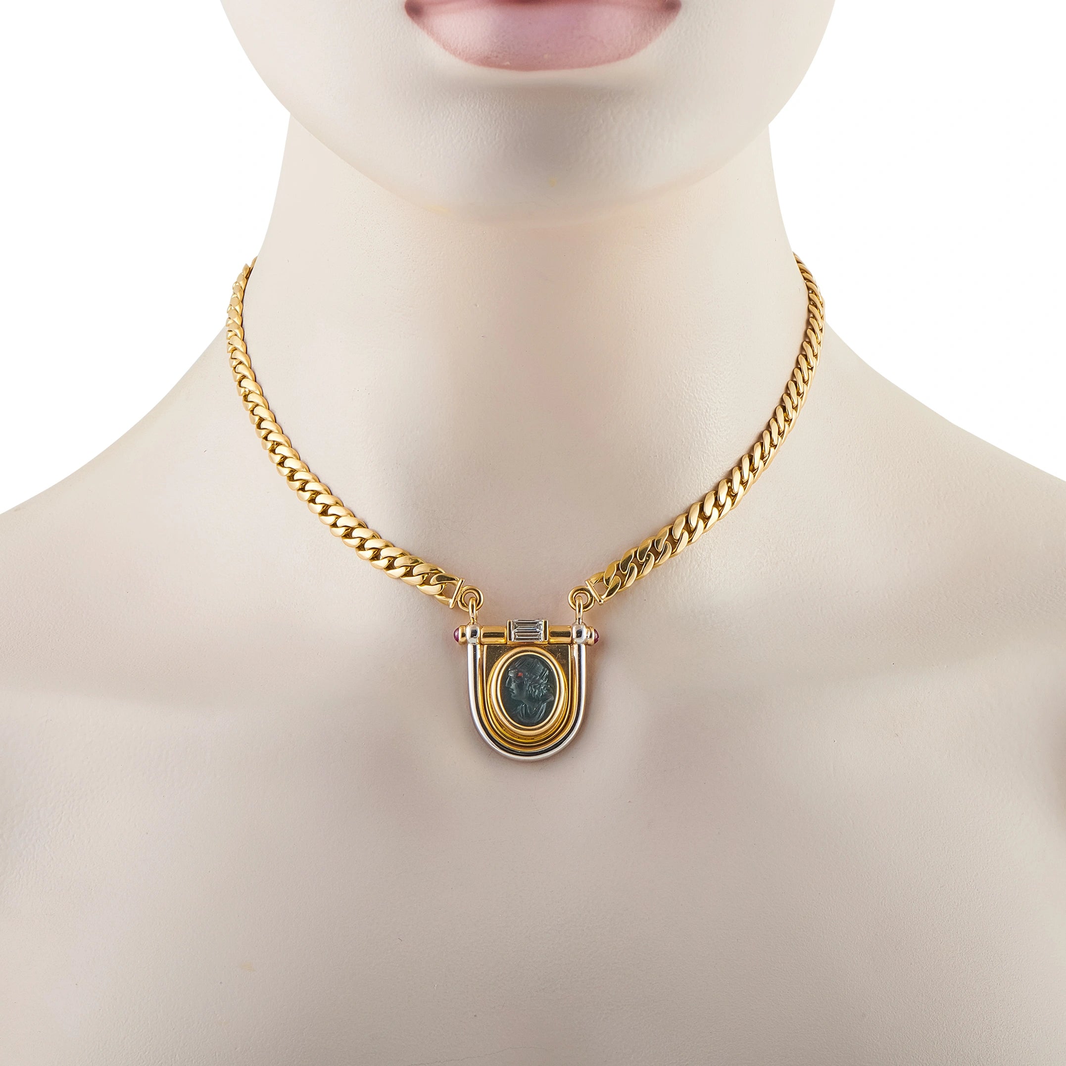 Gold necklace on mannequin with shield pendant, blue oval intaglio and purple ruby-like stones