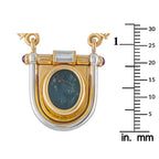 Gold shield pendant close-up with blue oval intaglio and baguette diamond accents