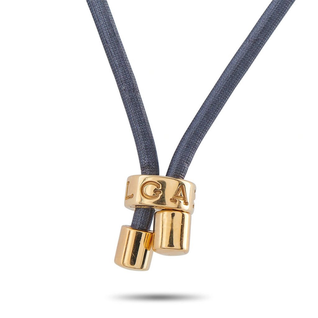 Gold clasp with engraved letters connecting blue cord to coin pendant