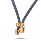Gold clasp with engraved letters connecting blue cord to coin pendant
