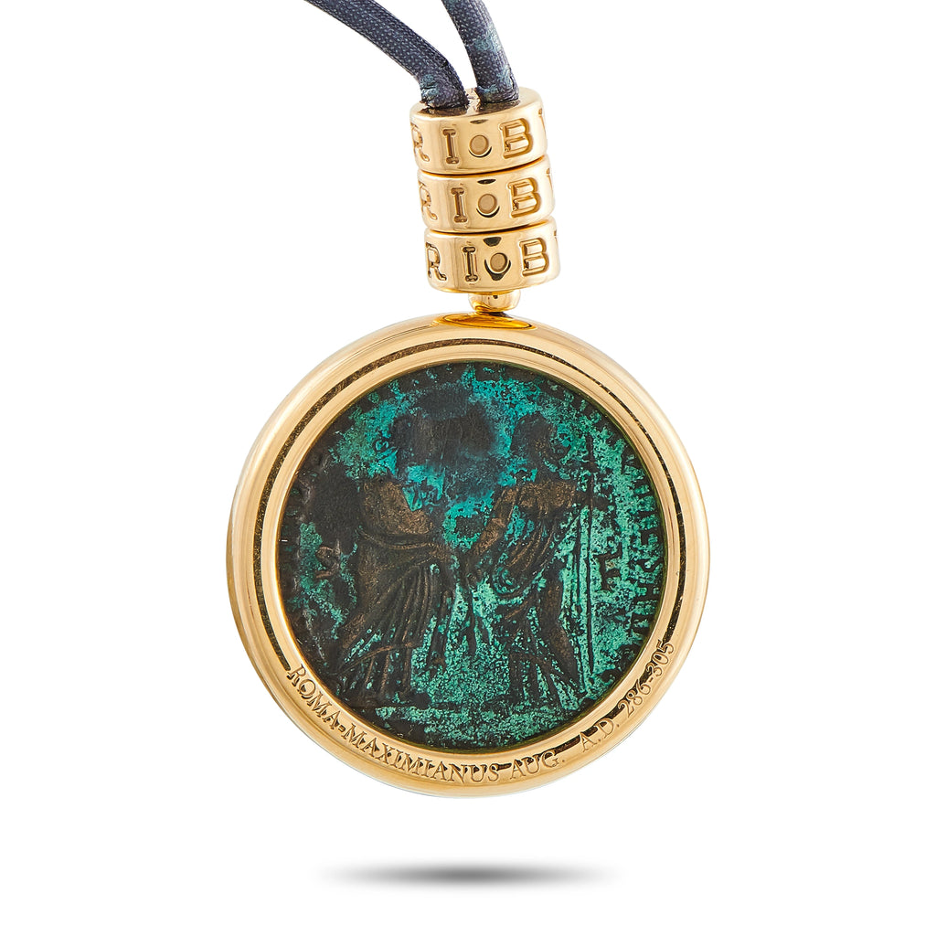 Round gold coin pendant with green-blue patina on blue cord
