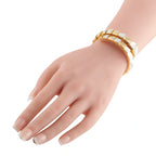 Yellow gold bracelet with mother-of-pearl insets, worn on wrist