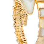 Close-up of gold scale-pattern links with mother-of-pearl inlay