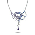 Diamond and sapphire drop necklace with swirling blue accents on a silver chain