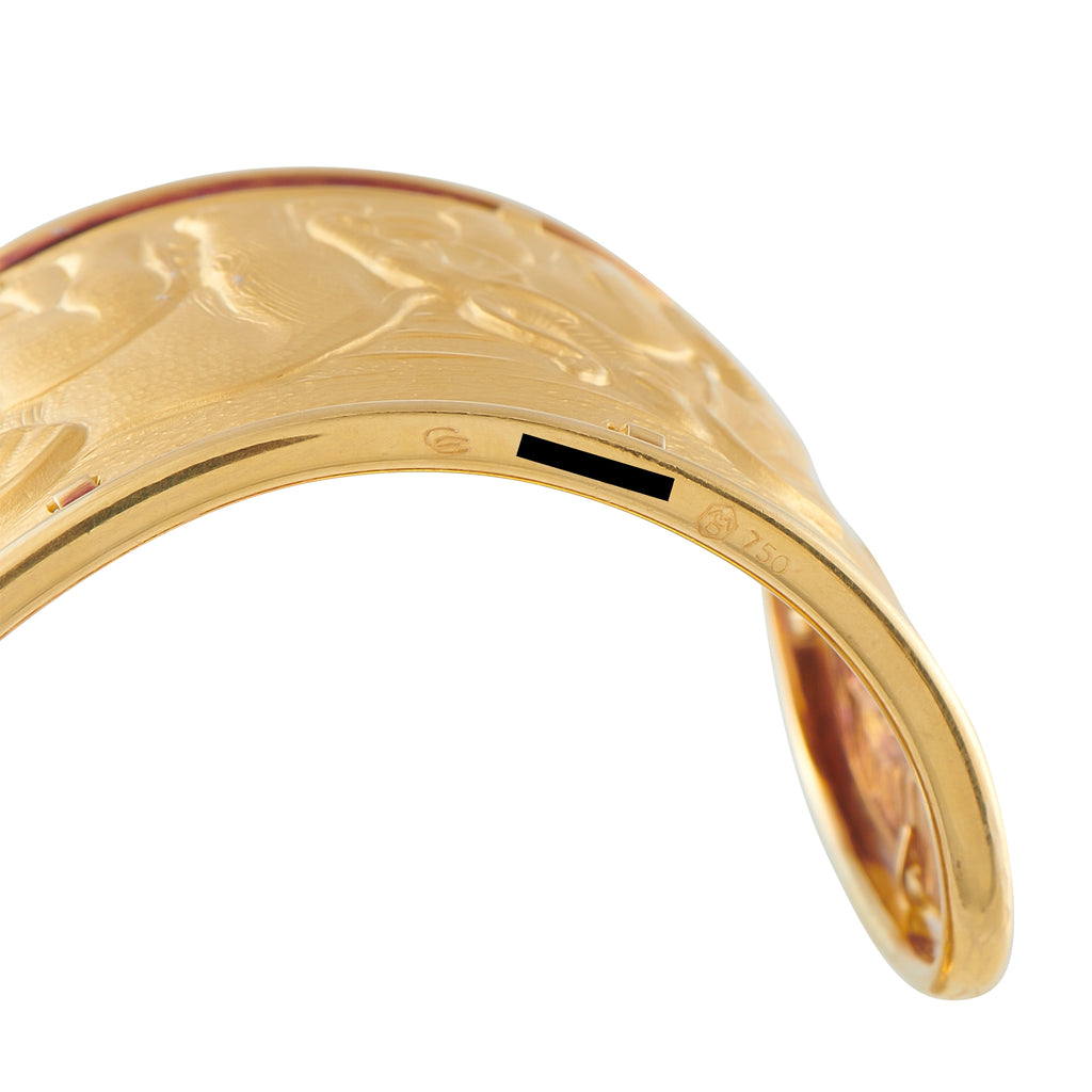 Yellow gold cuff bracelet with elephant engraving and dark inset detail