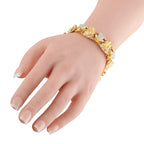 18K yellow gold frog bracelet on wrist with clear diamond accents and detailed links