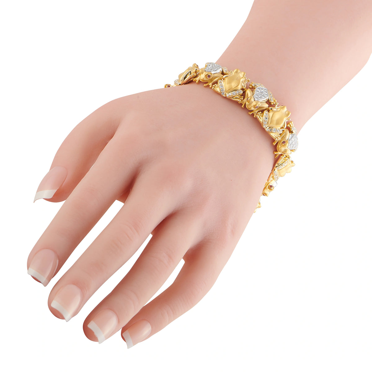 18K yellow gold frog bracelet on wrist with clear diamond accents and detailed links