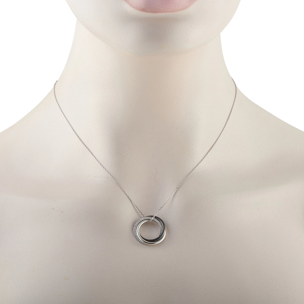 White gold necklace with circular black ceramic pendant on a thin chain